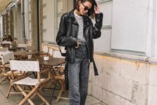 a Breton stripe top, grey straight leg jeans, black sneakers, a black leather jacket and a black and white bag