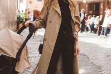 a black jumper, trousers, moccasins, a tan trench and a black bag for a timeless casual look