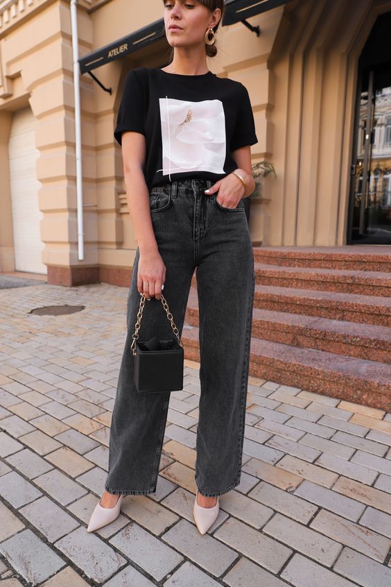 a black printed t-shirt, grey straight leg jeans, nude heels, a small black bag on chain for a cool and simple night out look