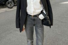 a chic outfit with a white button down, grey flare jeans, a black oversized blazer, black heels and a black hobo bag