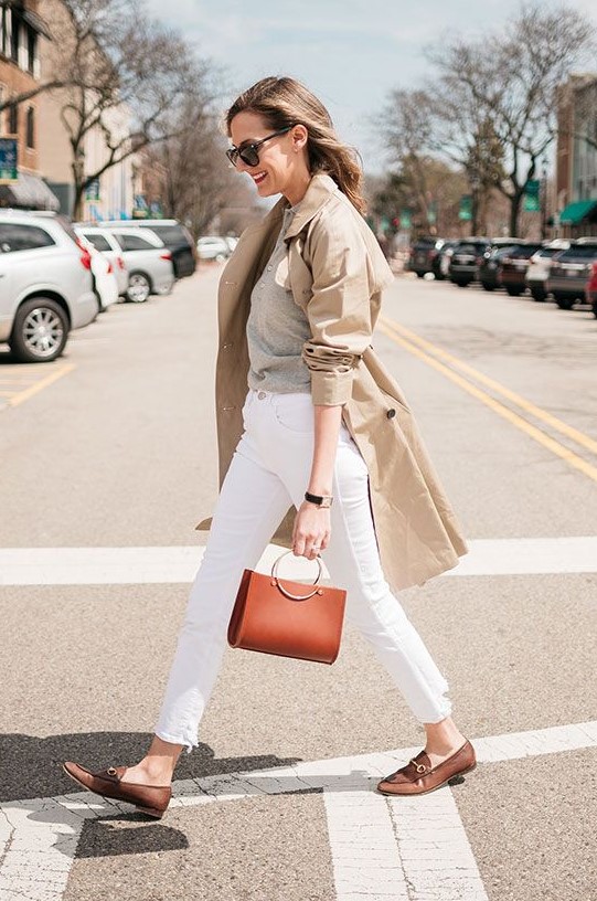 a grey cardigan as a shirt, white jeans, brown loafers, a red bag, a tan trench for a chic and timeless fall look