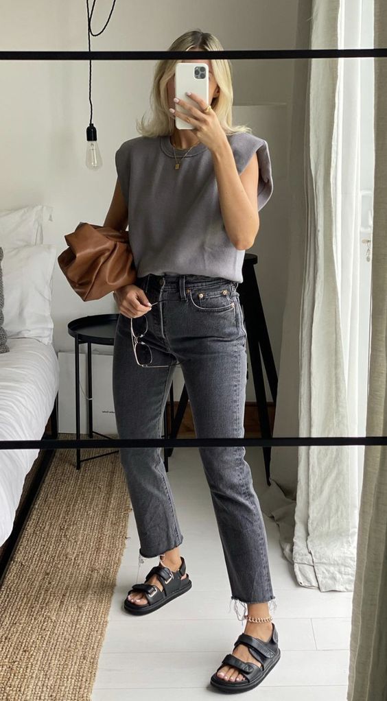 a grey top, grey cropped jeans, black sandals, a chain naklet and a brown clutch is a lovely and simple look for spring and summer
