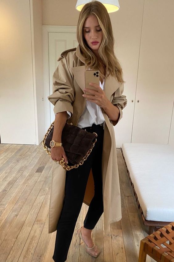a refined girlish outfit with a white oversized button down, black skinnies, nude mesh shoes, a beige oversized trench and a brown bag with chain