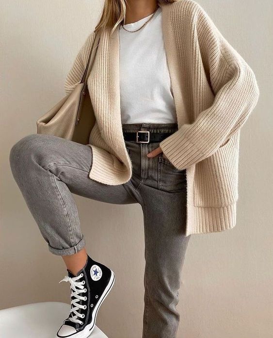 a simple everyday outfit with a white t-shirt, grey jeans, black sneakers, a tan cardigan and a tan tote