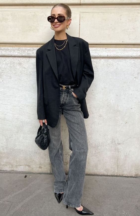 a sophisticated monochromatic look with a black tee, a black oversized blazer, black heels, a black hobo bag and grey jeans