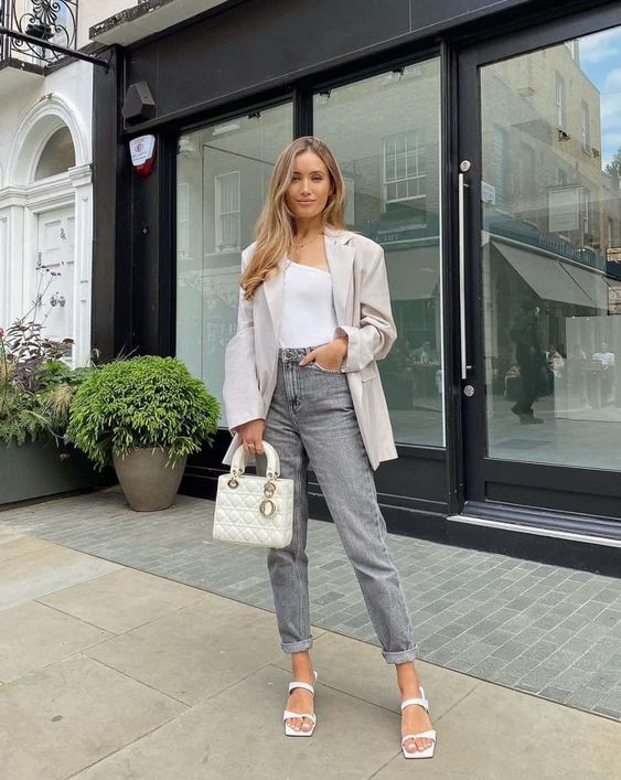 a white one shoulder bodysuit, grey jeans, white square toe shoes, a neutral oversized blazer and a white bag