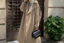an olive green shirt, beige jeans, white trainers, a beige trench, a black bag are a stylish look for spring