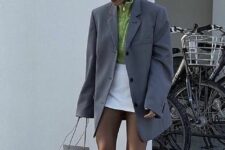 03 a neon green zip sweater, a white mini skirt, a grey oversized blazer, white trainers and socks, a white bag