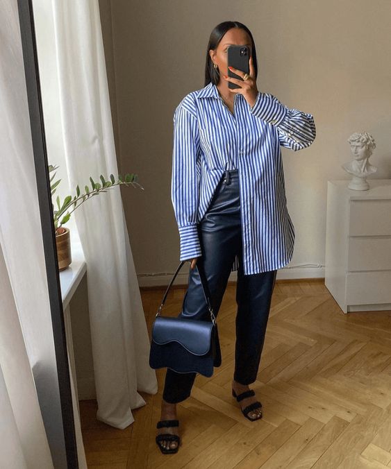a blue stripe shirt, black leather trousers, black strappy sandals and a black bag are a cool work outfit to rock