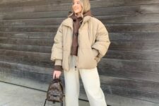 04 a winter outfit with a brown hoodie, ivory jeans, brown Jordans, a beige puffer, a brown printed backpack is easy and cool