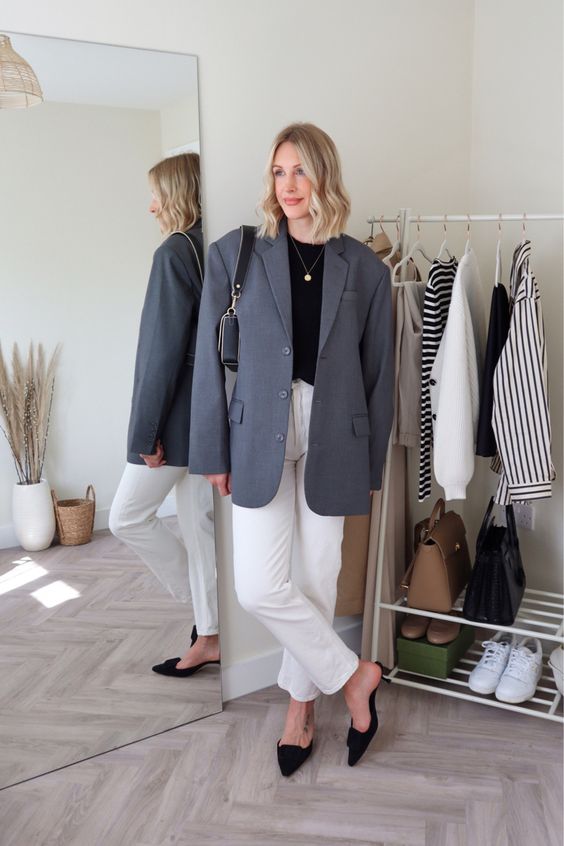 a minimalist work look for spring with white jeans, a black t-shirt, a graphite grey oversized blazer, black kitten heels and a black bag
