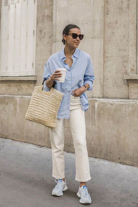 a blue striped shirt, ivory cropped jeans, white trainers, a straw bag are all you need for spring to summer time