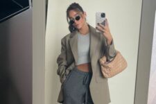 11 a sport chic look with a grey crop top, graphite grey shorts, a greige blazer, green Jordan sneakers and a woven bag