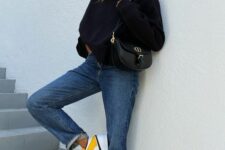 14 a black sweatshirt, blue jeans, yellow Jordan sneakers and an elegant black bag for spring or fall