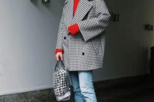 16 a bold look with a red sweater, cropped blue jeans, an oversized printed coat, white sneakers and a catchy bag