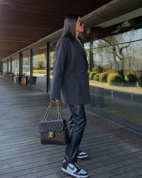 a black oversized blazer, black leather pants, black Jordan sneakers and a black embossed bag with chain for the fall