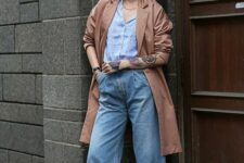 22 a blue striped shirt, blue wide leg jeans, white Gazelle sneakers, black socks, a copper trench and a printed bag