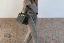 24 a grey tracksuit, green striped socks, grey NEw Balance trainers and a black tote are a great look for spring