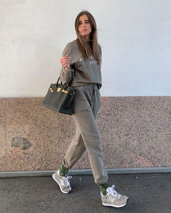 a grey tracksuit, green striped socks, grey NEw Balance trainers and a black tote are a great look for spring