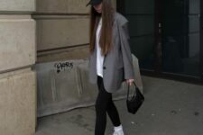 31 a white oversized tee, black leggings, grey trainers and white socks, an oversized grey blazer, a black cap and a black bag