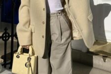 32 a white tank top, grey trousers, a pastel yellow oversized blazer, white and yellow Jordan sneakers and a yellow bag for spring