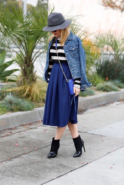 With black and white striped long sleeved shirt, gray and black wide brim hat, sunglasses, blue leather chain strap bag and black patent leather mid calf heeled boots
