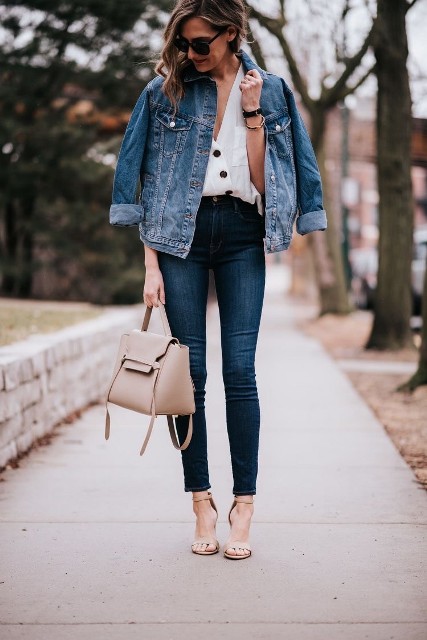 With oversized sunglasses, white button down loose shirt, beige leather tote bag and beige leather ankle strap high heels