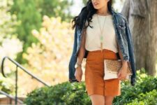 With oversized sunglasses, white shirt, necklace, white and brown printed clutch and light brown leather cutout ankle boots