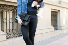 With rounded oversized sunglasses, black and blue striped sweater, black leather clutch and black patent leather lace up flat shoes