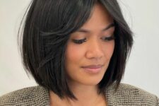 a black blunt bob with short curtain bangs and central part is a timeless idea that always looks elegant