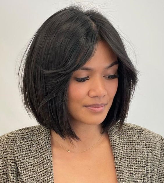 a black blunt bob with short curtain bangs and central part is a timeless idea that always looks elegant