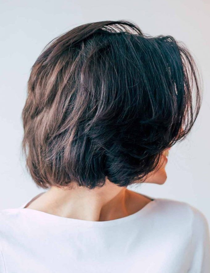 a black choppy bob with center parted bangs that help to freshen things up
