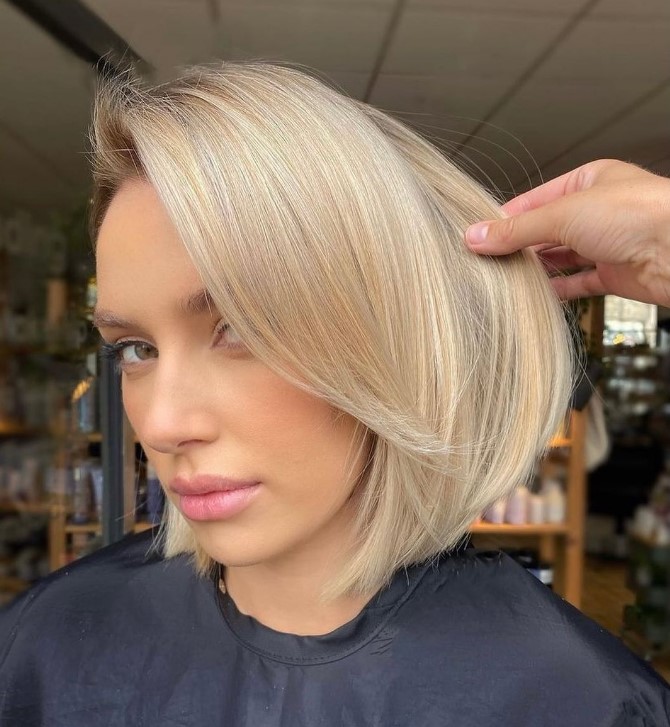 a blonde chin length bob with curtain bangs is a very up-to-date and fresh idea to rock right now