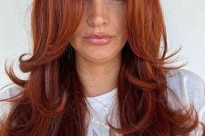 a fab red butterfly haircut on long hair, with a lot of volume, face-framing layers and curled ends is jaw-dropping