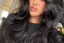 a gorgeous black butterfly haircut with curled ends, a lot of volume and curtain bangs is amazing