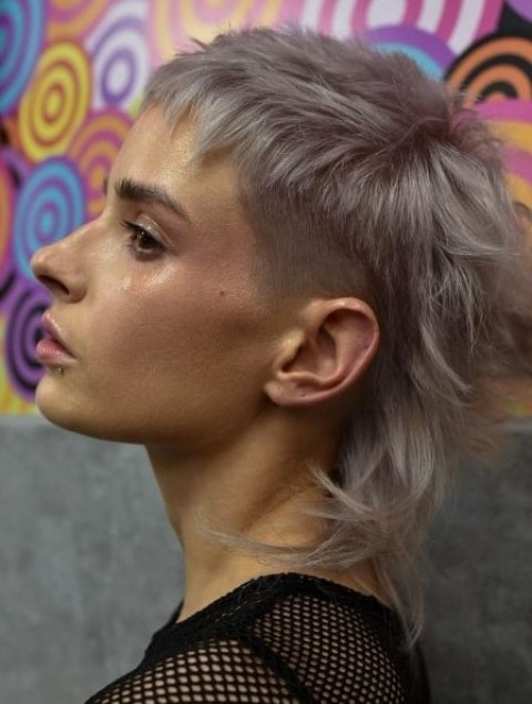 a grey-colored mullet with a fade to the sides of the hair to give it structure and create a slight contrast