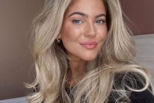 a long and fluffy blonde butterfly haircut with balayage, with curled ends and a lot of volume is a catchy and chic idea