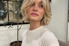a natural-looking blonde chin length bob with side bangs and curved ends is a classic and simple hairstyle