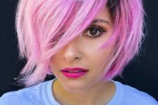 a pink choppy bob with dark roots with sharp layers that will make the color even more outstanding with its dramatic locks falling on one another freely