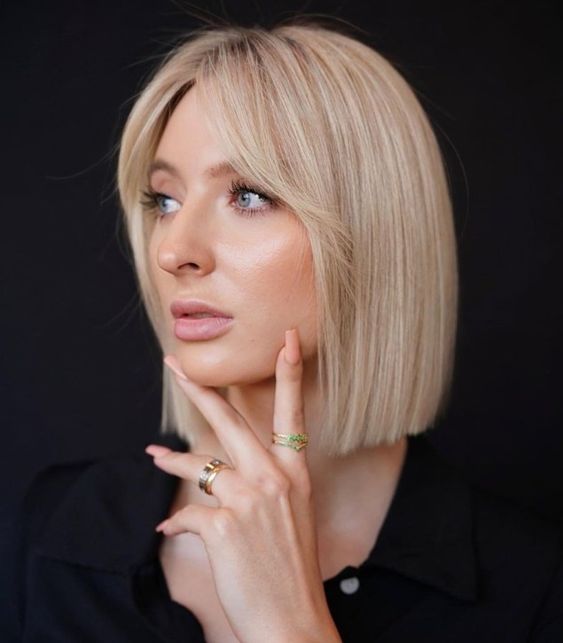 a refined icy blonde blunt bob with short curtain bangs is a cool and chic idea for anyone and it looks elegant