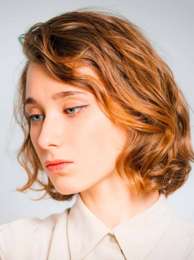a side-parted mid-length choppy bob is an elegant solution and soft wavy layers add interest