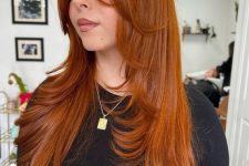 a stunning bright copper long butterfly haircut with face-framing layers and curled ends is amazing