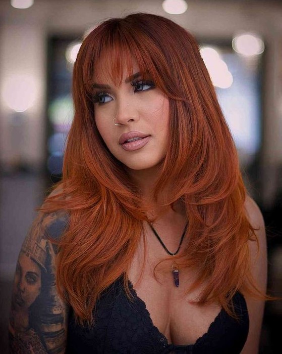 an extra bold long copper butterfly haircut is amazing to look jaw-dropping, wispy bangs accent the eyes