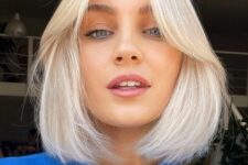 an icy blonde bob with short curtain bangs is a fresh and cool hairstyle that looks timelessly elegant