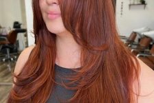 an inspiring and beautiful red butterfly haircut on long hair, with much volume and long curtain bangs is wow