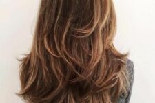 beautiful brown long hair with caramel balayage and a butterfly haircut to give it volume and interest