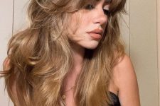 bronde to golden blonde butterfly hair with dimensional side bangs and waves is a lovely and chic idea