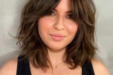 medium length chestnut hair with short curtains bangs and messy waves is a chic and beautiful idea with a romantic feel