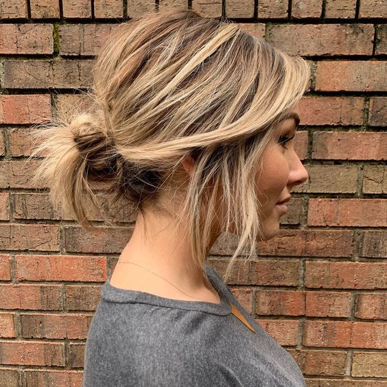a messy low bun with a messy and textured top and some locks down is fast to make and comfy to wear