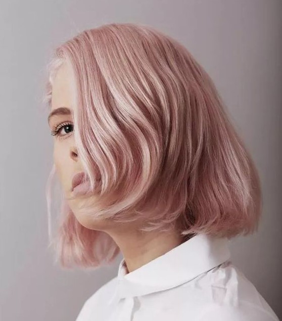 a millennial pink short bob with curved ends is a chic and lovely idea, both edgy and timelessly elegant